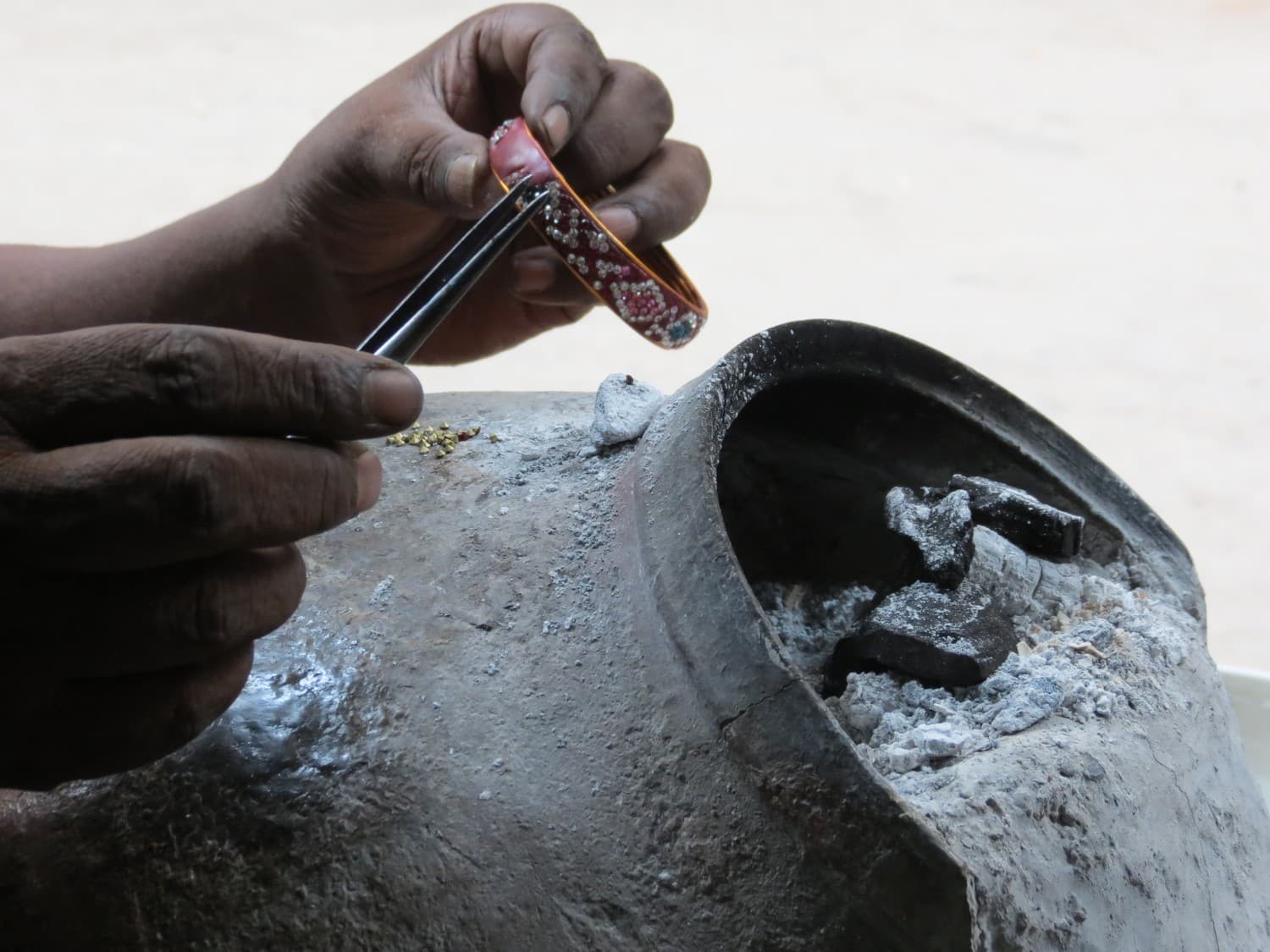 Hands at a jeweller's workbench in Jaipur