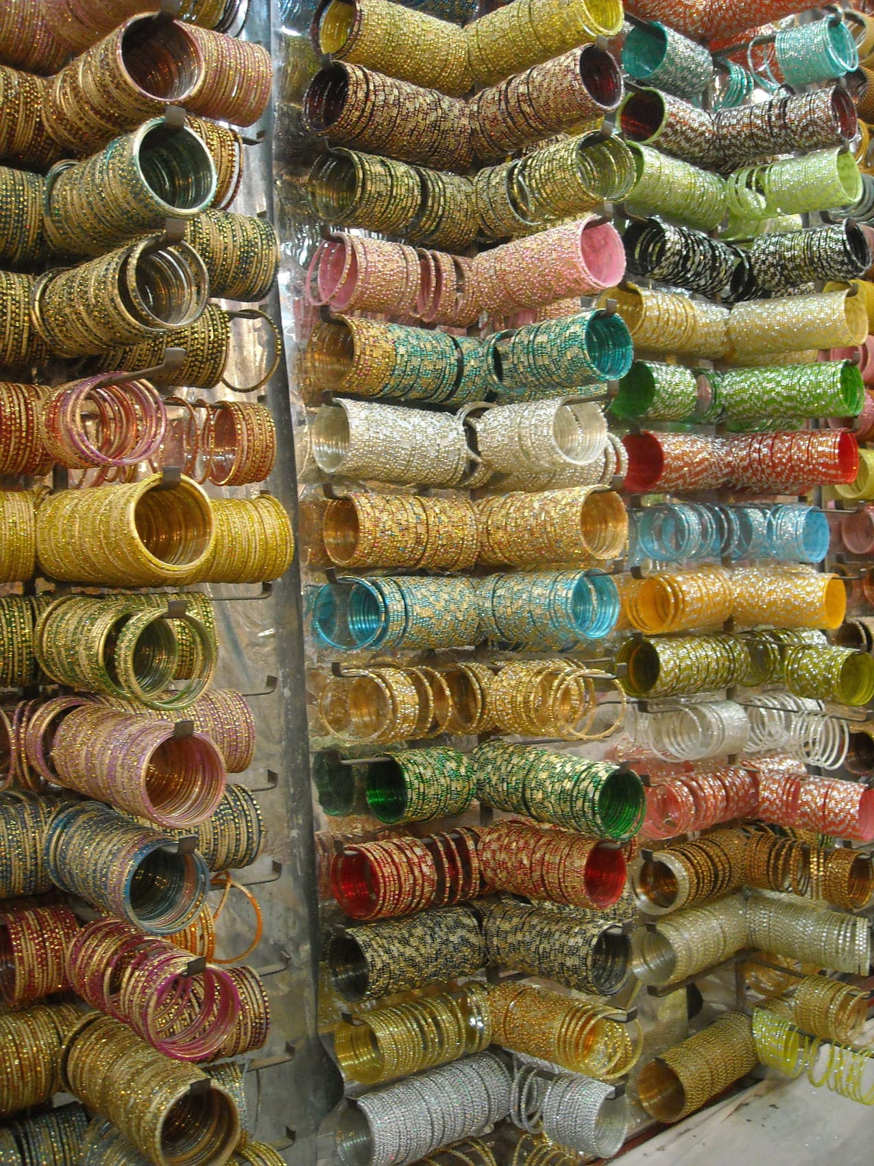 Shelves of brightly coloured bangles and jewellery at a Jaipur bazaar stall